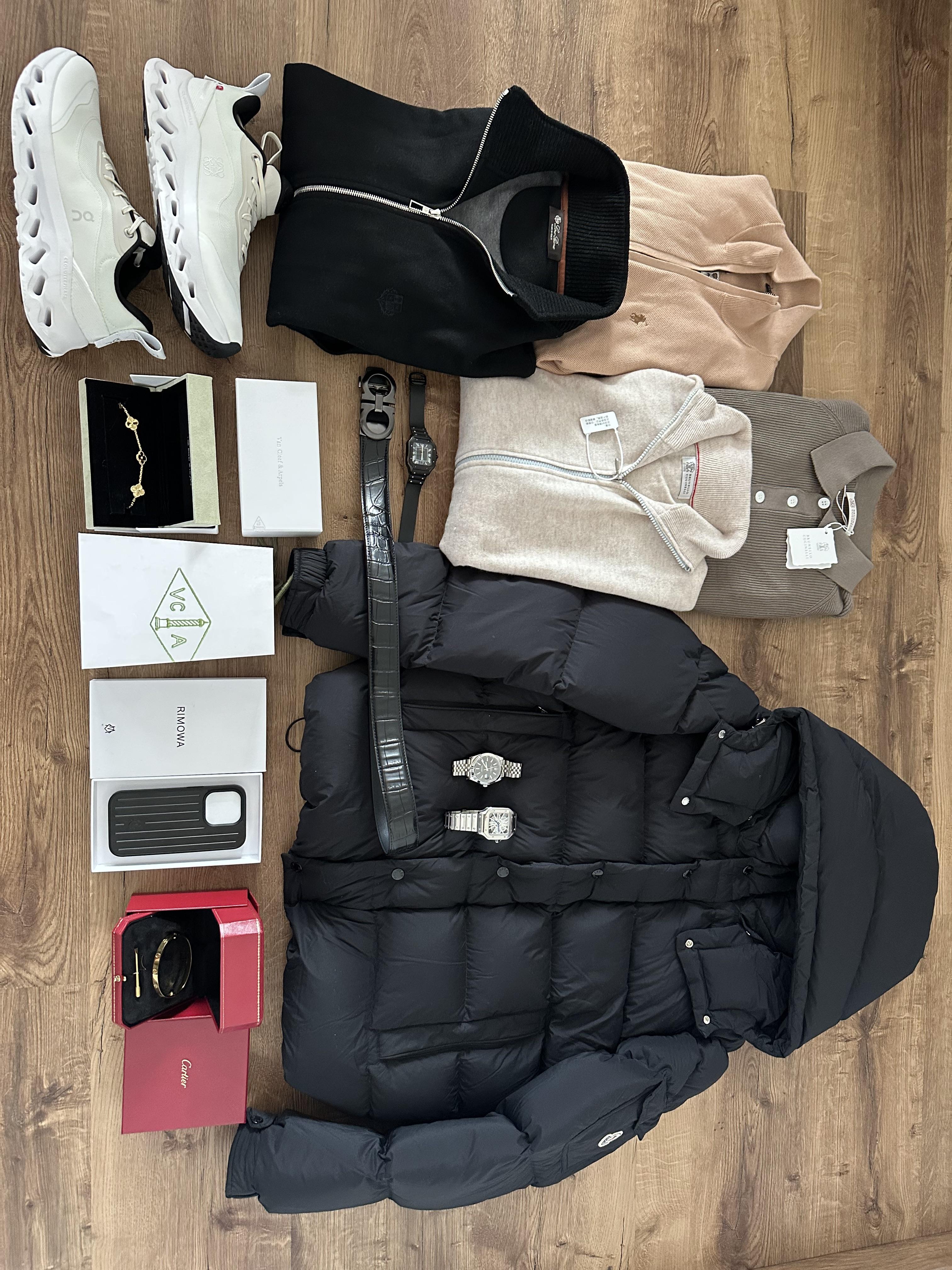 Down jacket, knitwear, shoes and accessories laid out in the Reddit author's winter haul photo